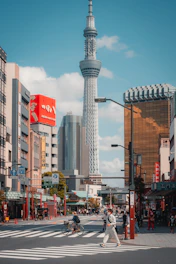 a man crossing a street in front of a tall building