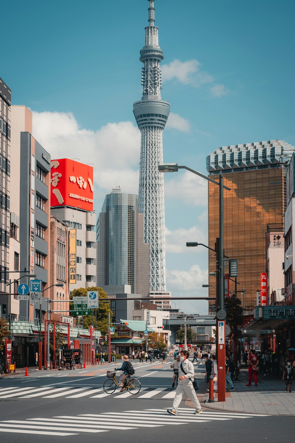 a man crossing a street in front of a tall building