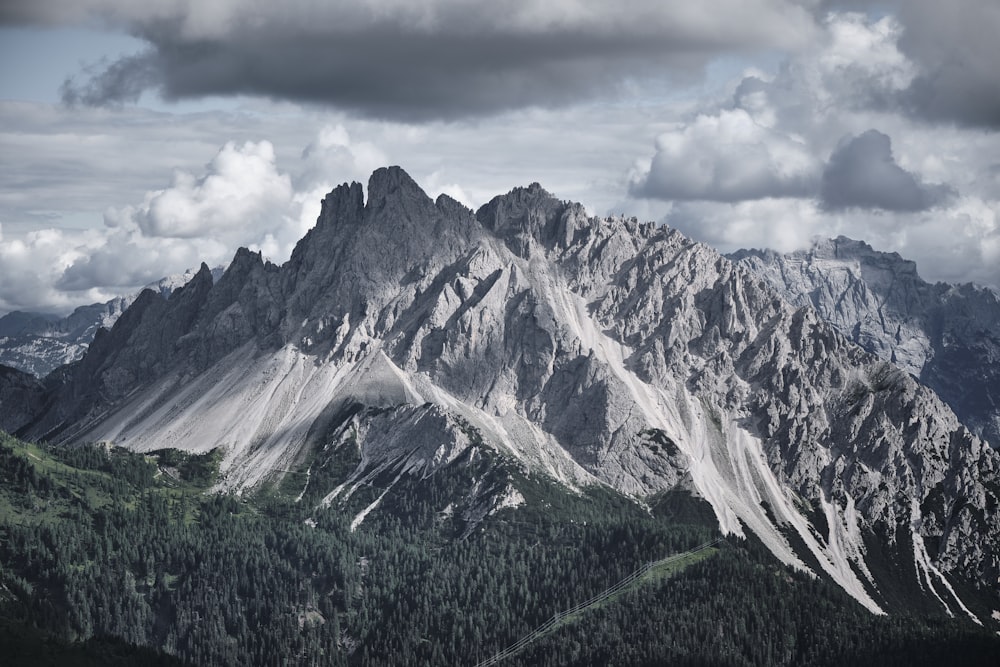 a mountain range with a cloudy sky in the background