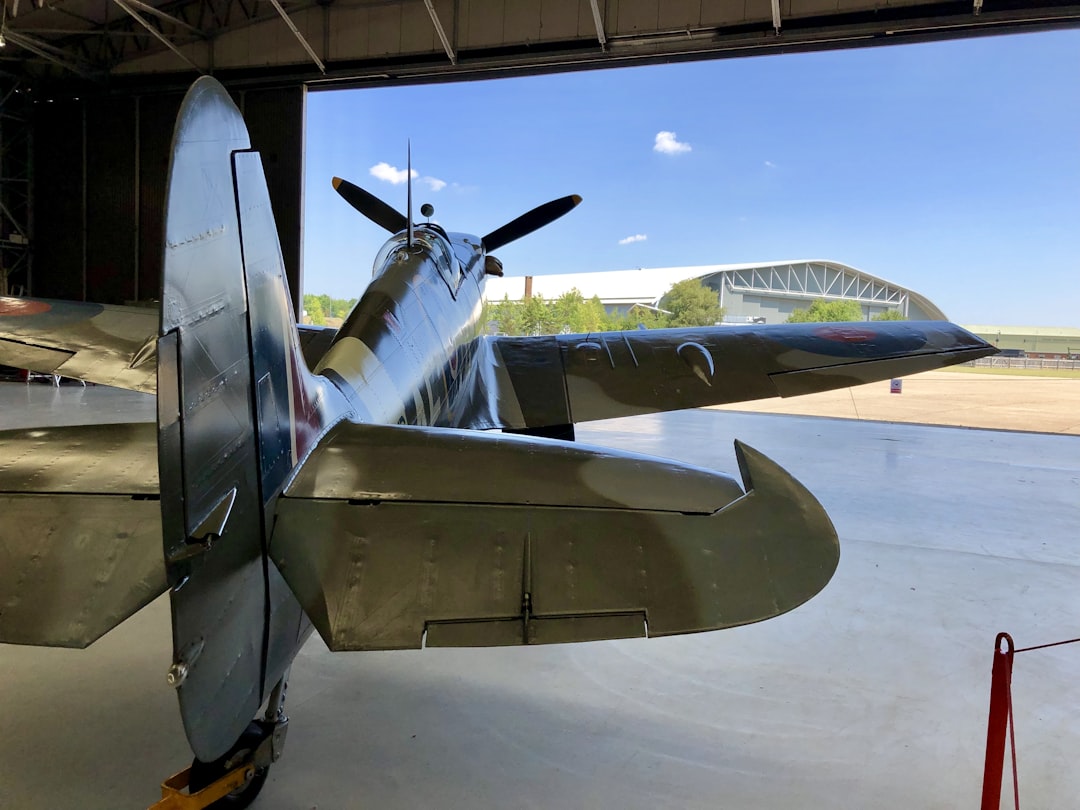 a propeller plane sitting inside of a hangar, Good old Spitfire