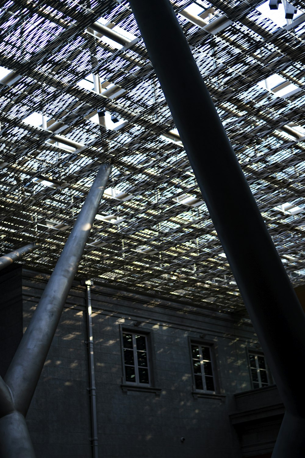 a building with a roof made of metal pipes