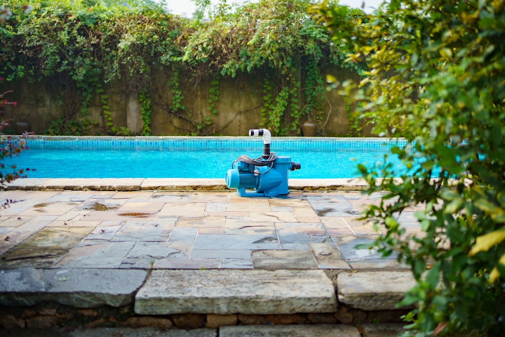 a pool with a water pump in the middle of it