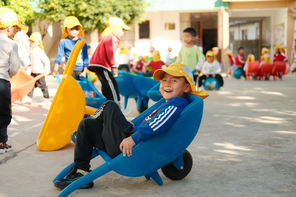 a young boy sitting in a blue chair