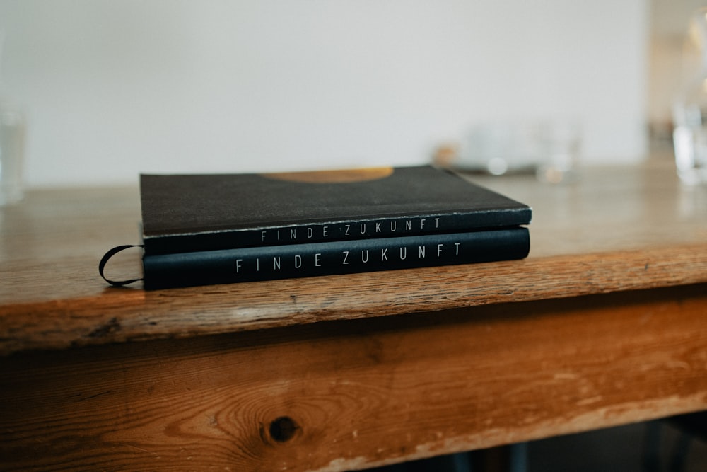 a couple of books sitting on top of a wooden table