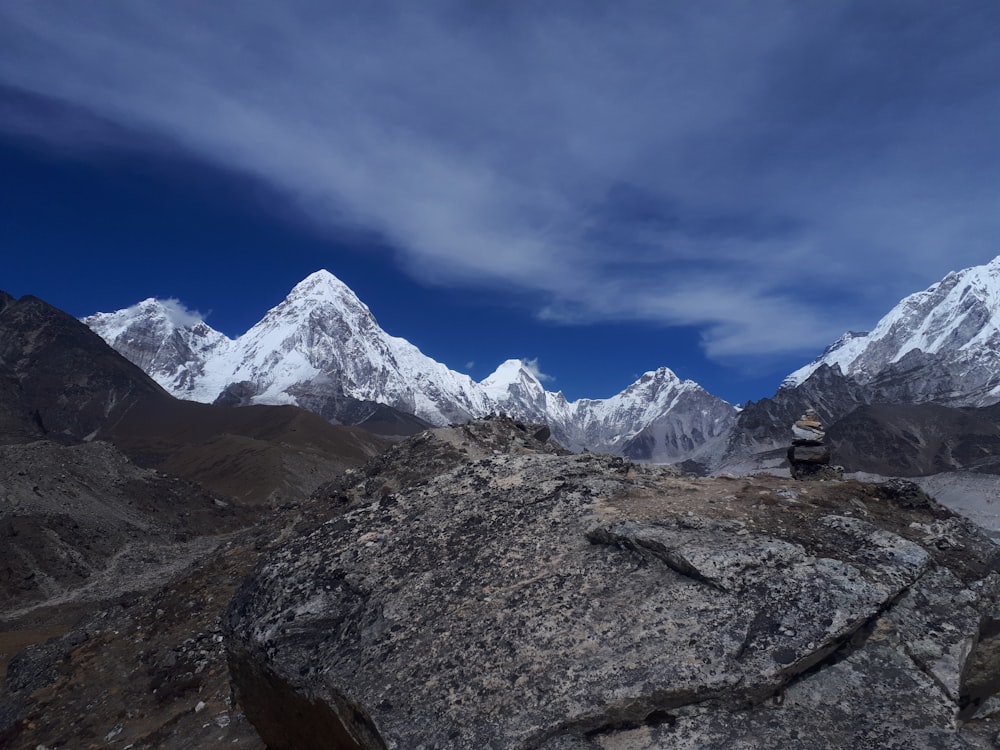 a man standing on top of a large rock