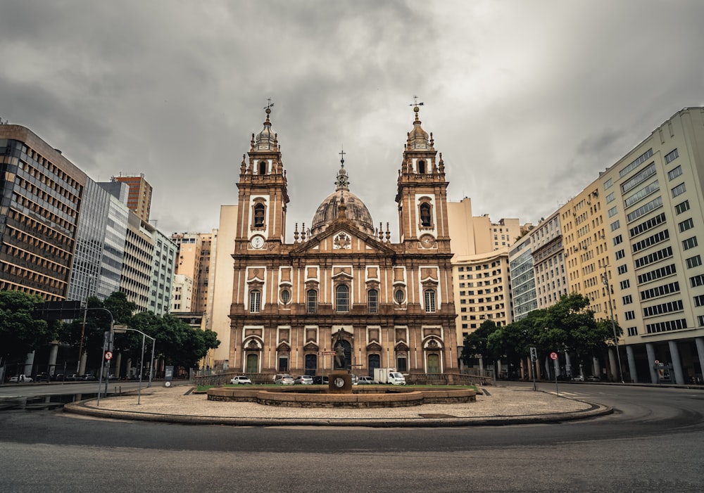 a large building with two towers and a fountain in front of it