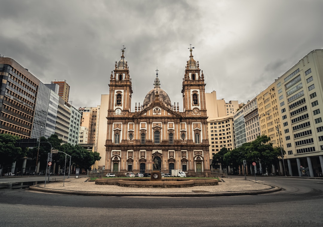 a large building with two towers and a fountain in front of it,