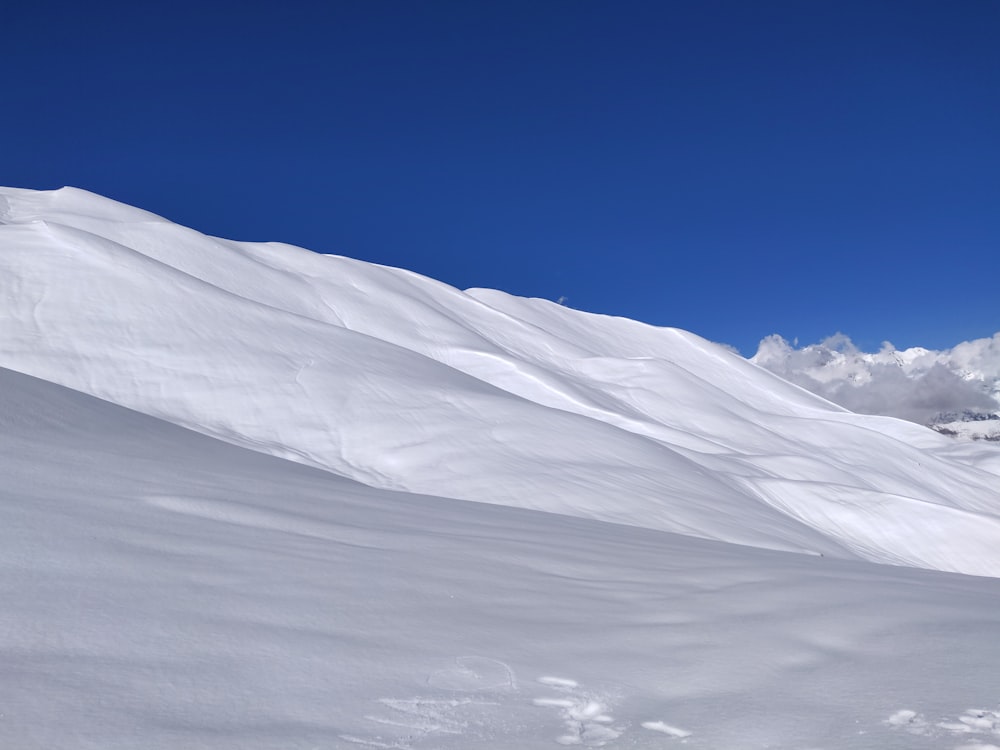 a man riding skis down a snow covered slope