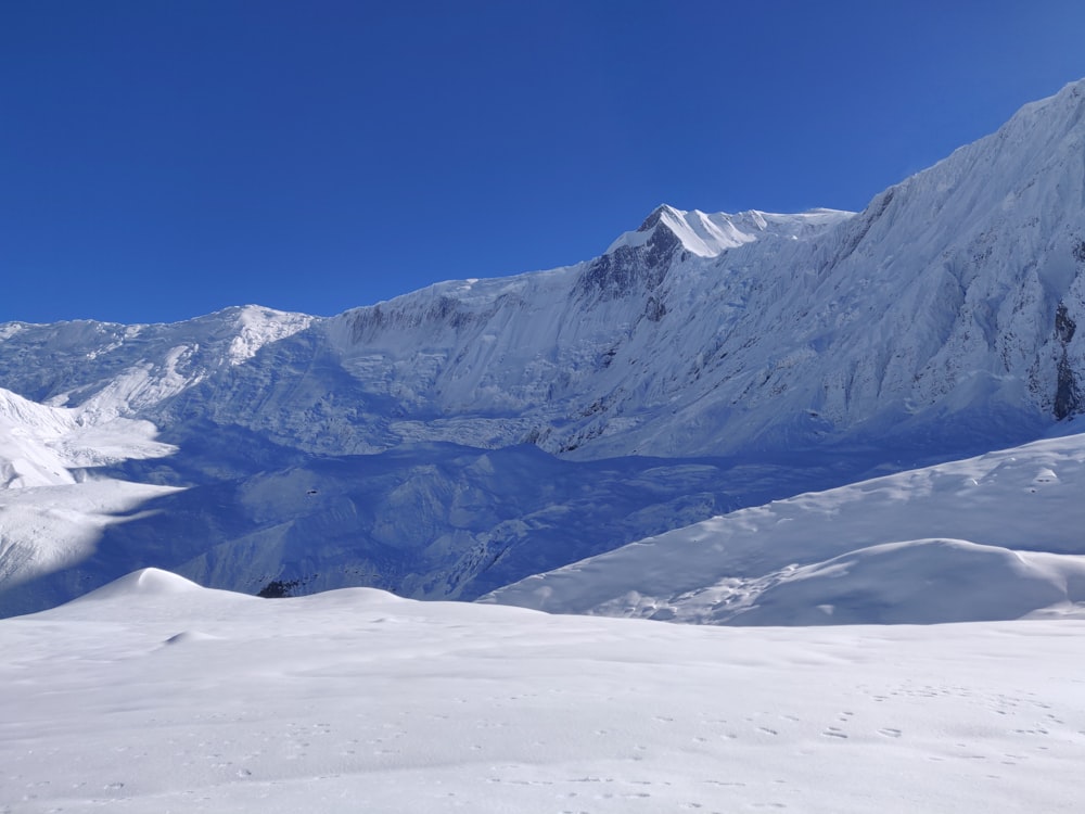 a person standing on a snow covered mountain