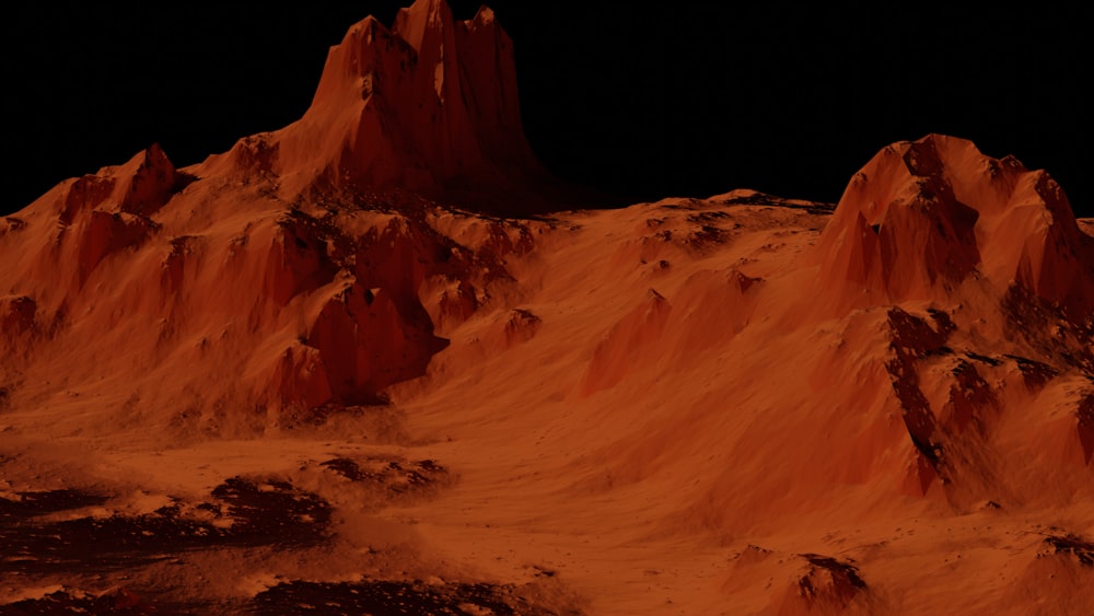 um grupo de montanhas cobertas de areia à noite