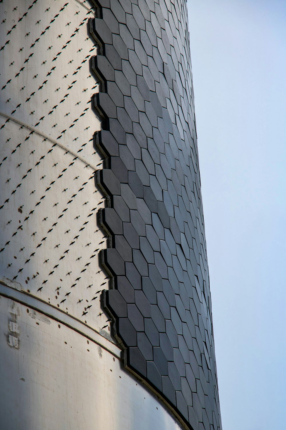 a close up of a metal structure with a sky background