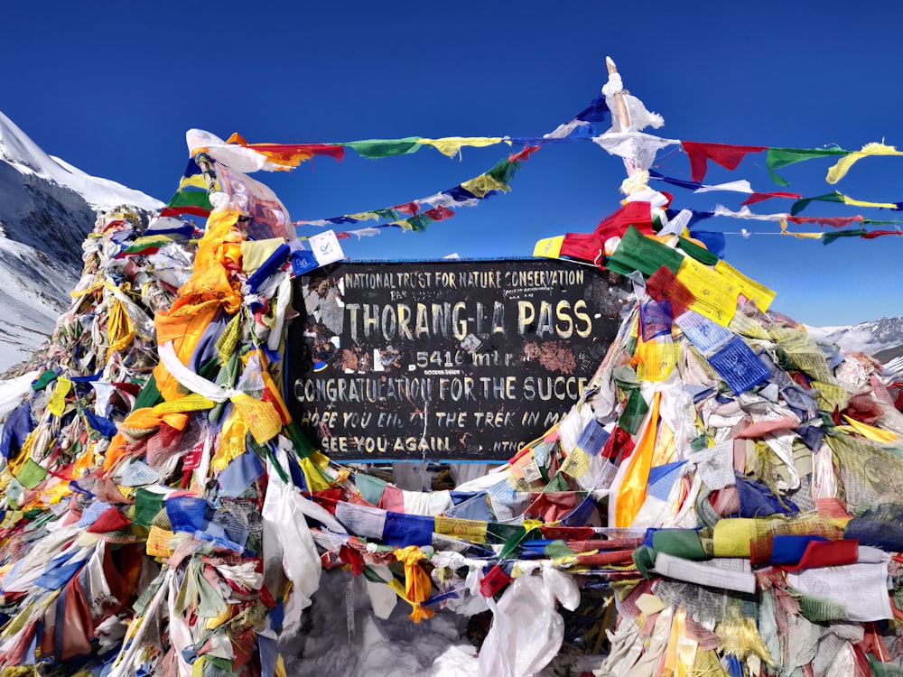 a sign surrounded by colorful flags and streamers