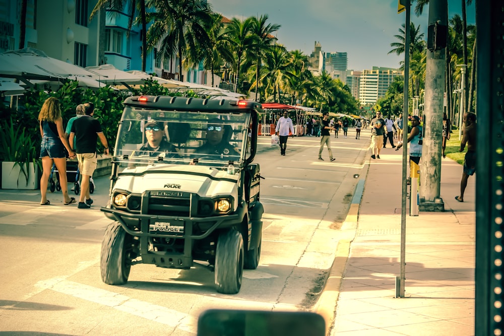 a golf cart driving down a city street