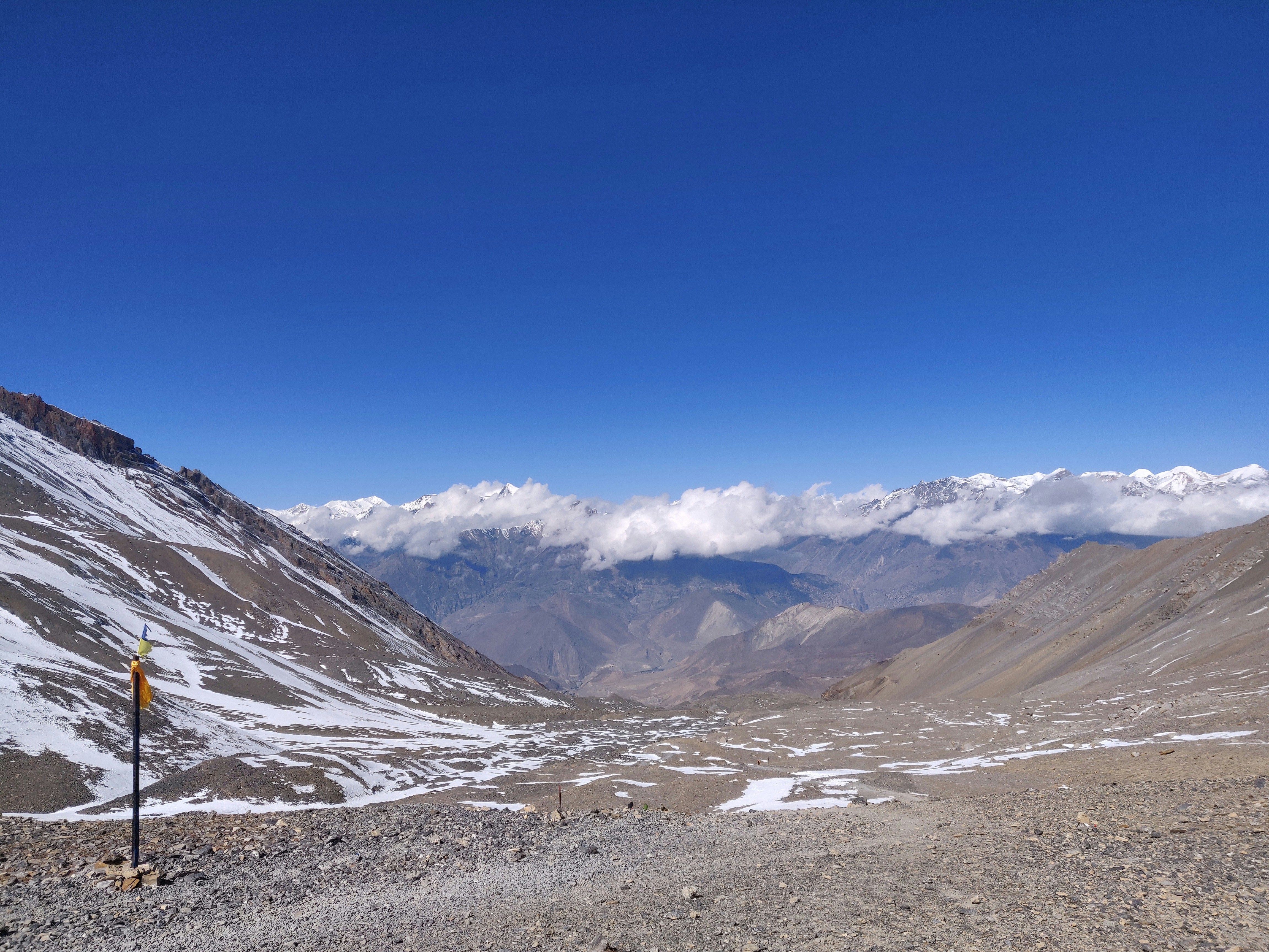 a view of a mountain range with a sign in the foreground