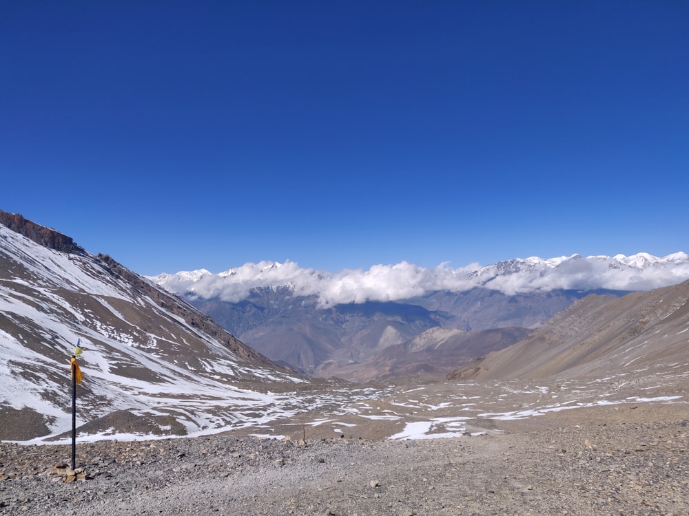 a view of a mountain range with a sign in the foreground