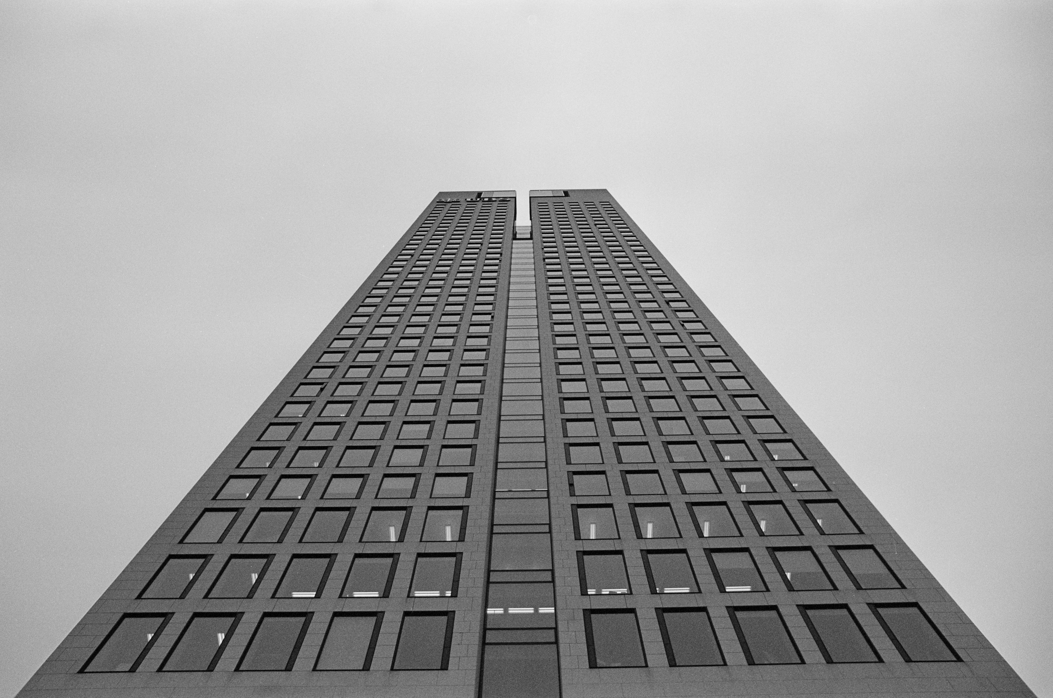 Modern office bank building skyscraper. Urban architecture storefront – finance district Frankfurt am Main. Leica R7 (1994), Elmarit-R 2.8 28mm (1977). Hi-Res analog scan by: www.totallyinfocus.com – Kodak BW 400CN (expired 2004)