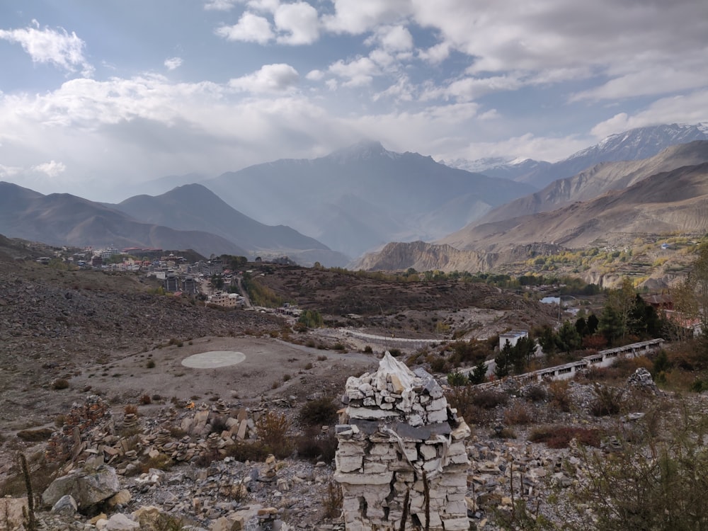 a stone structure in the middle of a mountain valley