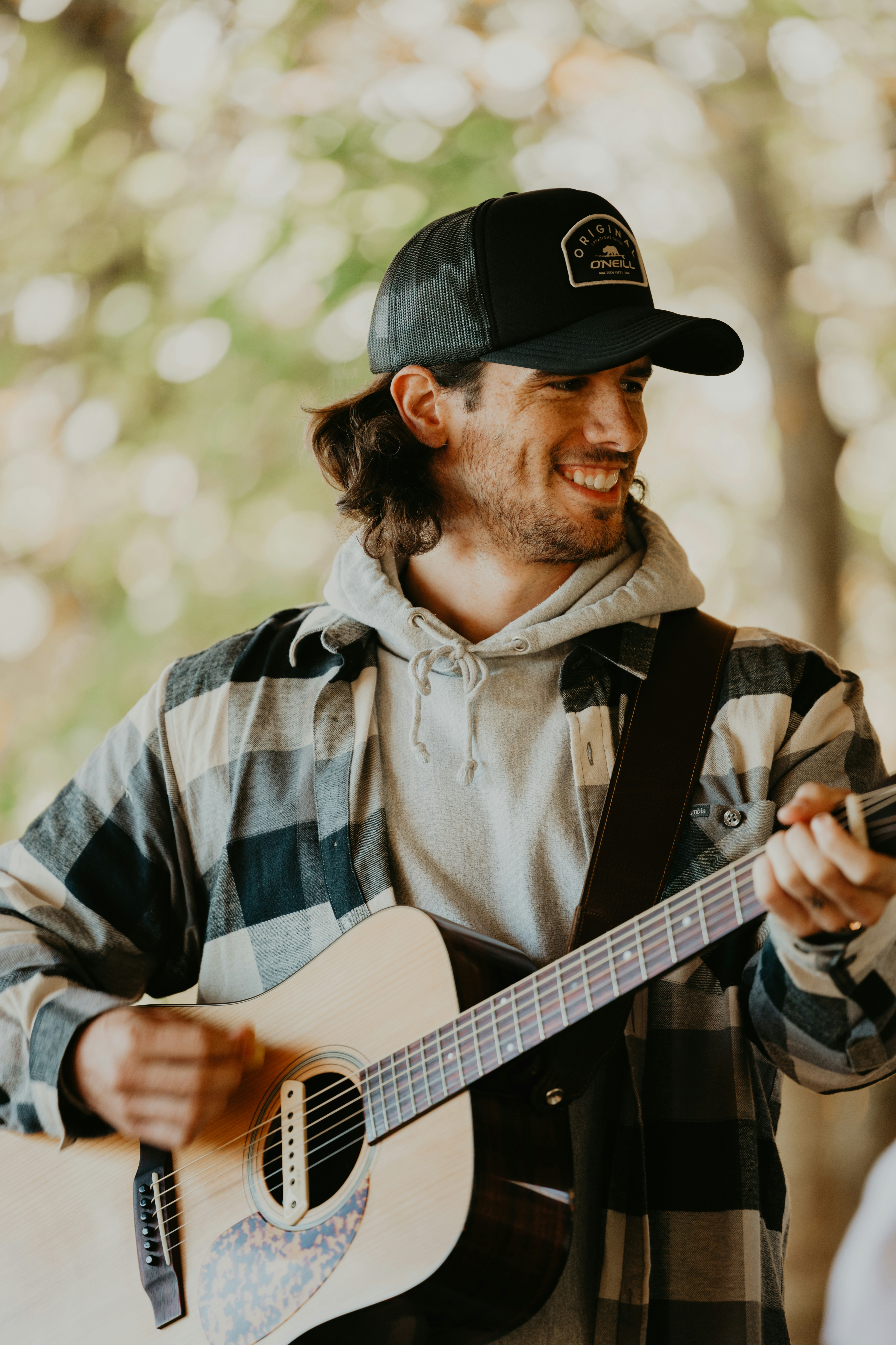 a man with a hat playing a guitar