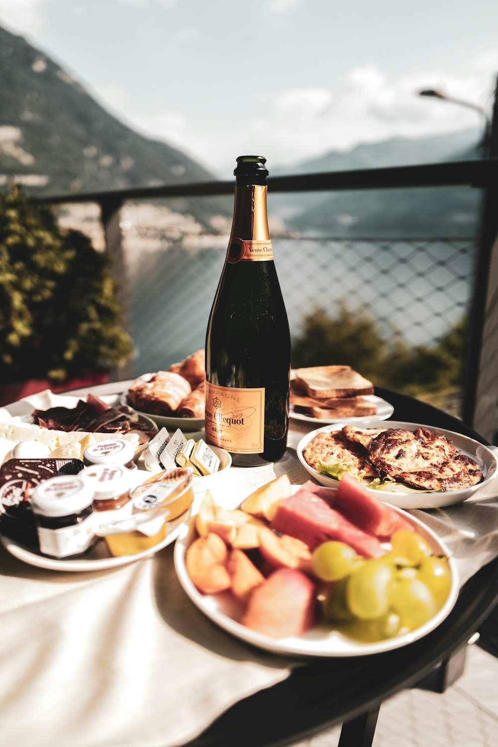 a bottle of wine sitting on top of a table filled with food