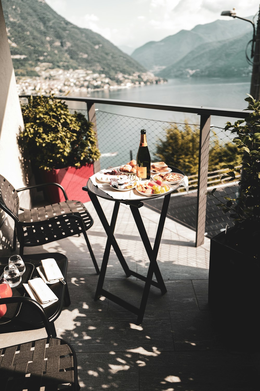 a table with a bottle of wine and a plate of food on it