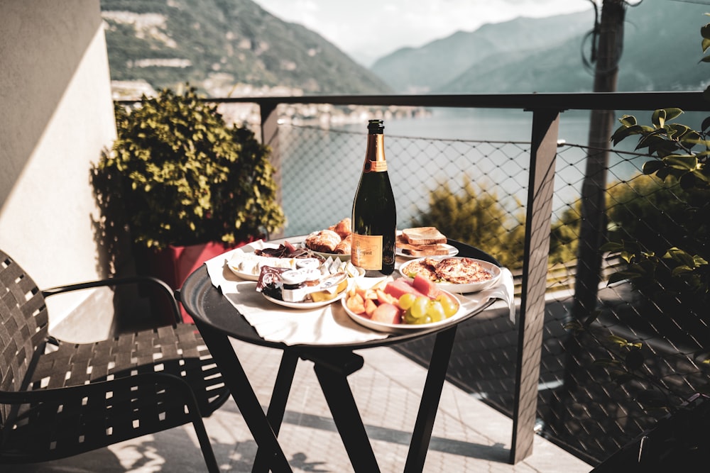 a plate of food and a bottle of wine on a table