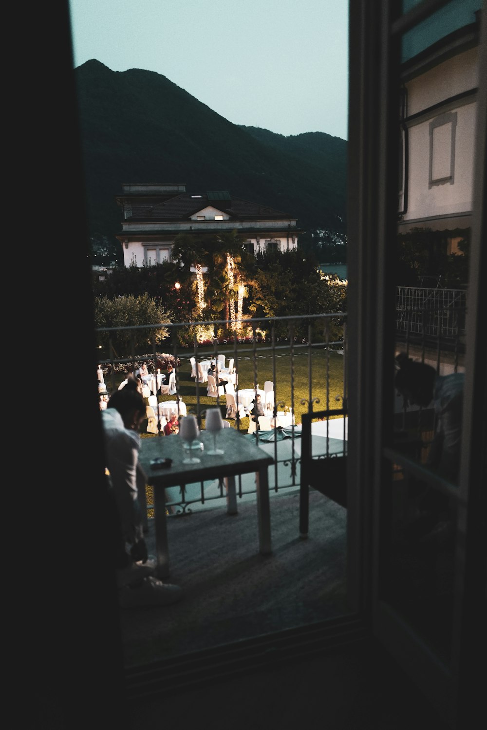 a person sitting at a table on a balcony