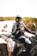 a man riding a four wheeler on top of a sandy beach