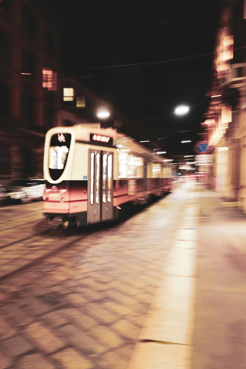 a red and white train traveling down train tracks