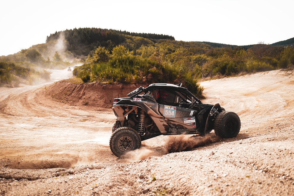 a person riding a buggy on a dirt road