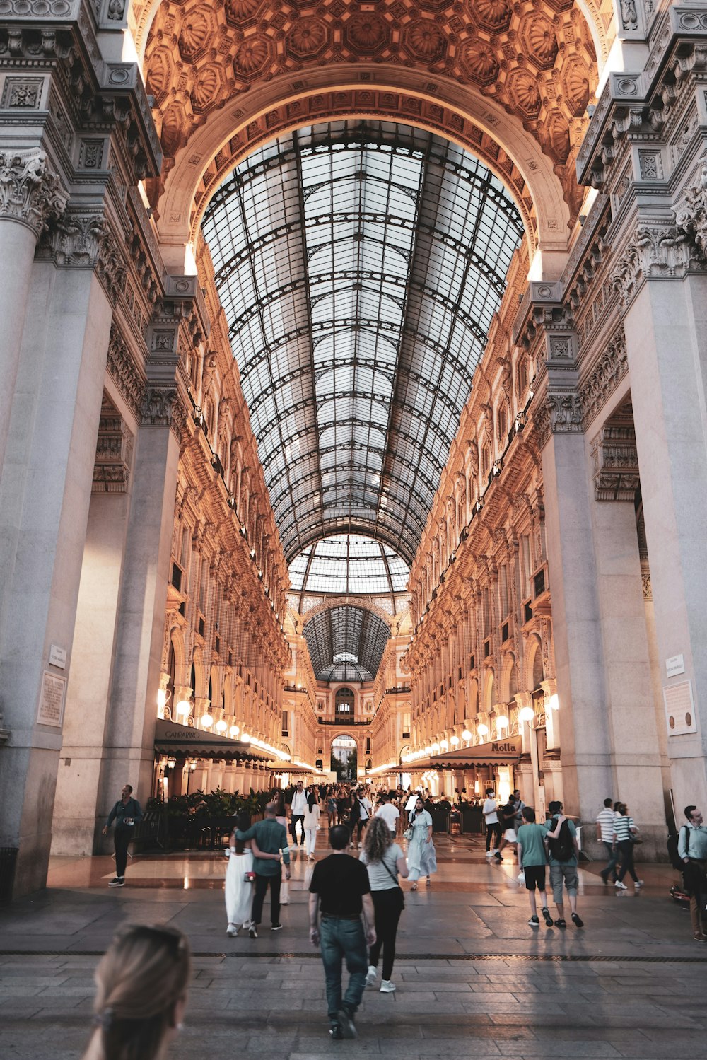 a group of people walking through a large building