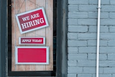 a sign that says we are hiring and apply today