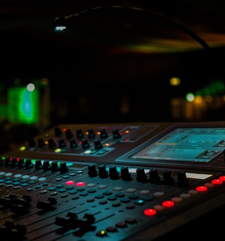 a sound mixing console in a dark room
