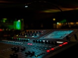a sound mixing console in a dark room