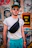 a man with a fanny bag standing in front of a wall