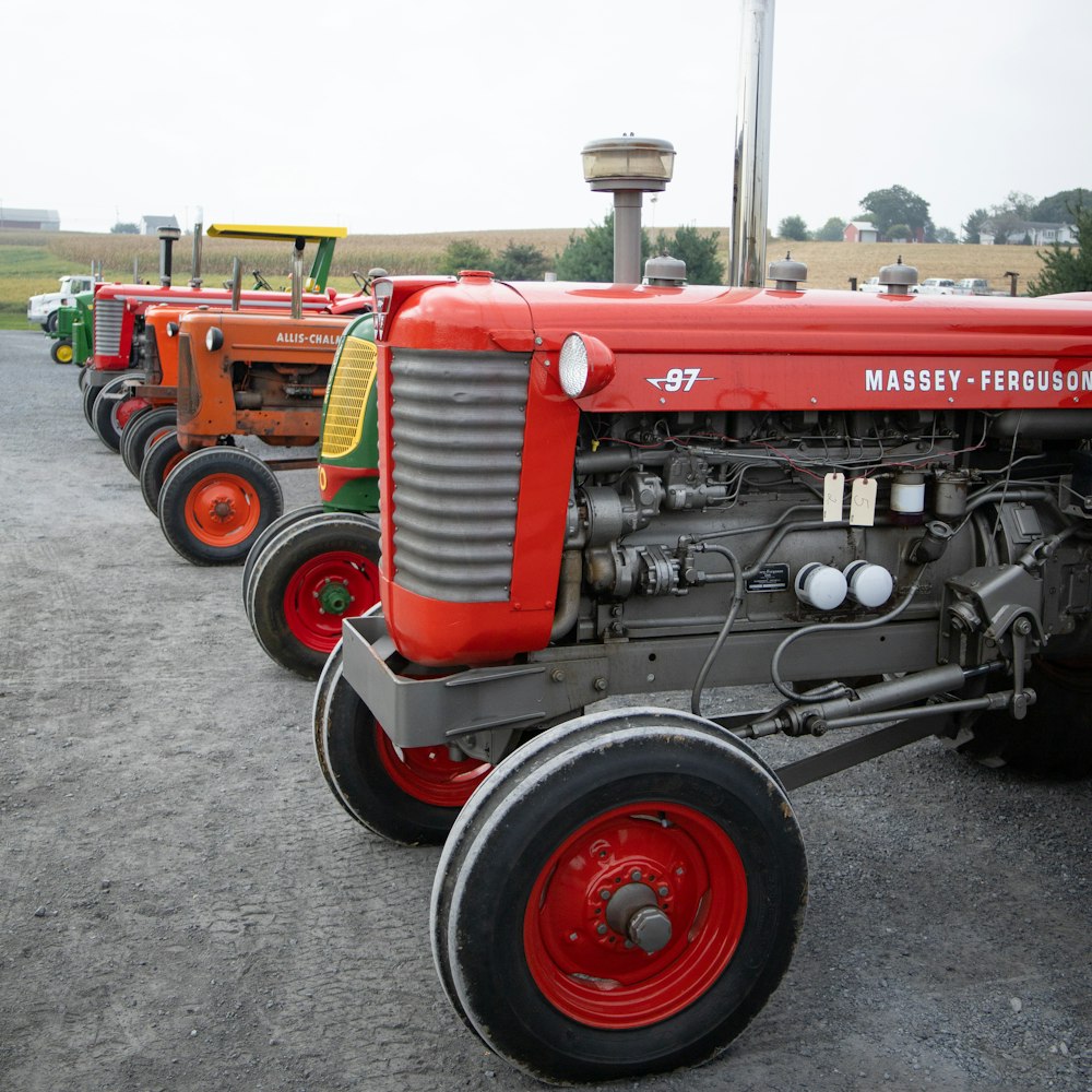 a row of farm tractors parked in a parking lot