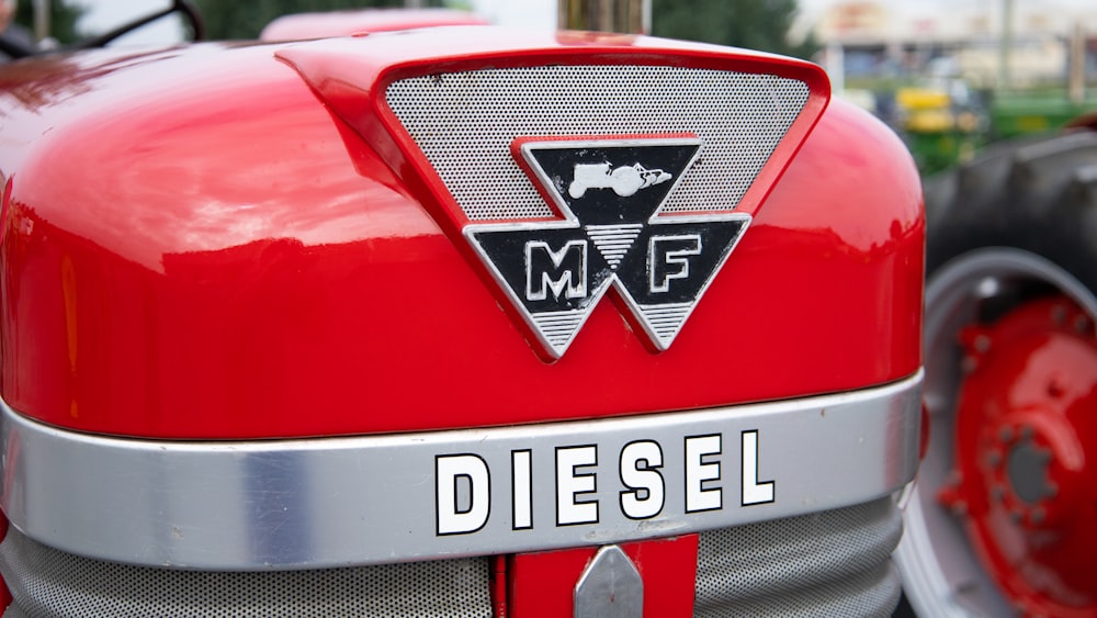 a close up of the emblem on the front of a red tractor