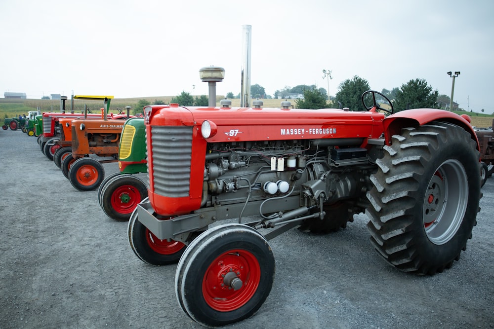 a row of farm tractors parked in a parking lot