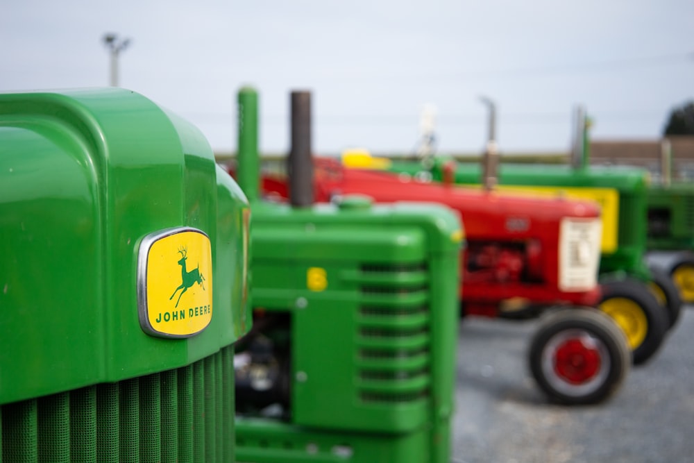 a row of green tractors sitting next to each other