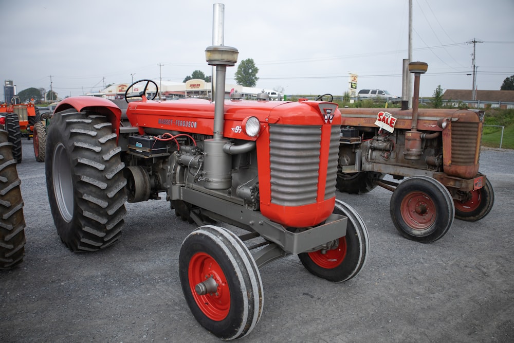 a red tractor parked in a parking lot