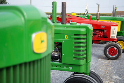 a row of green tractors sitting next to each other
