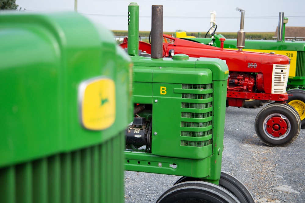 a row of green tractors sitting next to each other