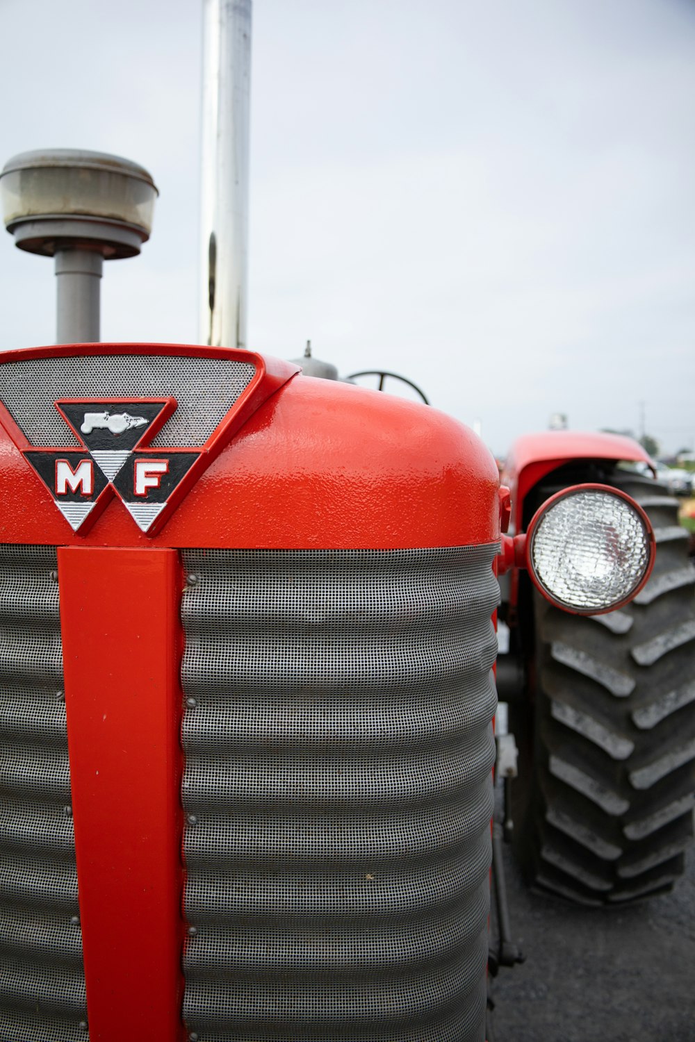 a close up of the front of a red tractor