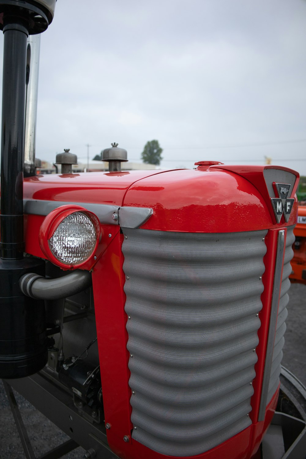 a close up of the front of a red tractor