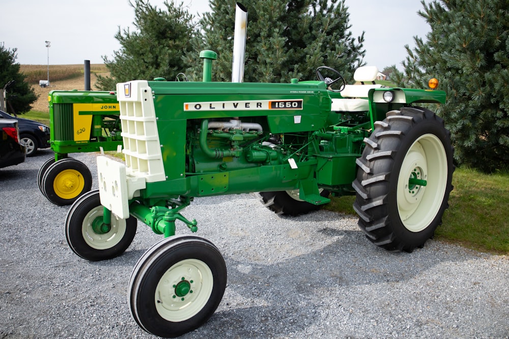 a green and white tractor parked in a parking lot