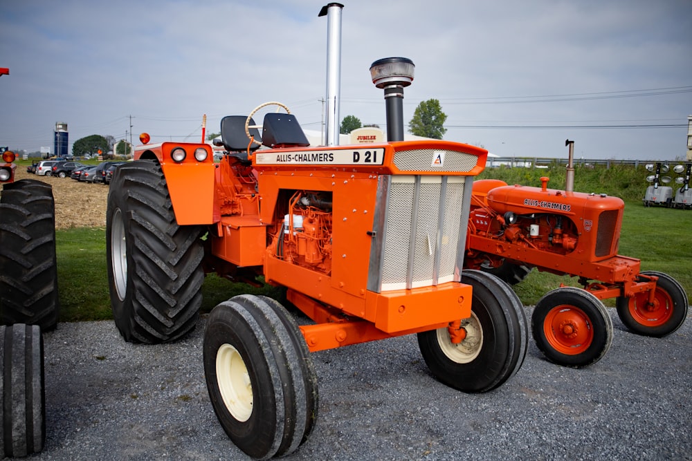 an orange tractor parked in a parking lot