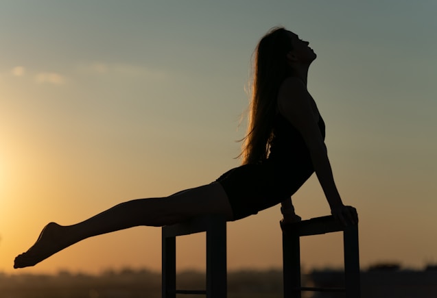 a woman sitting on top of a metal chair