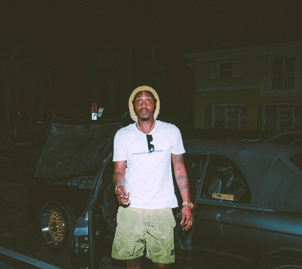 a man standing in front of a car