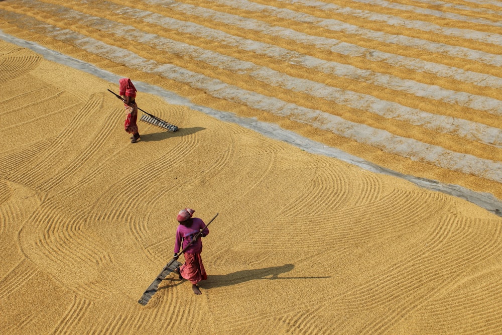 a couple of people that are standing in the dirt