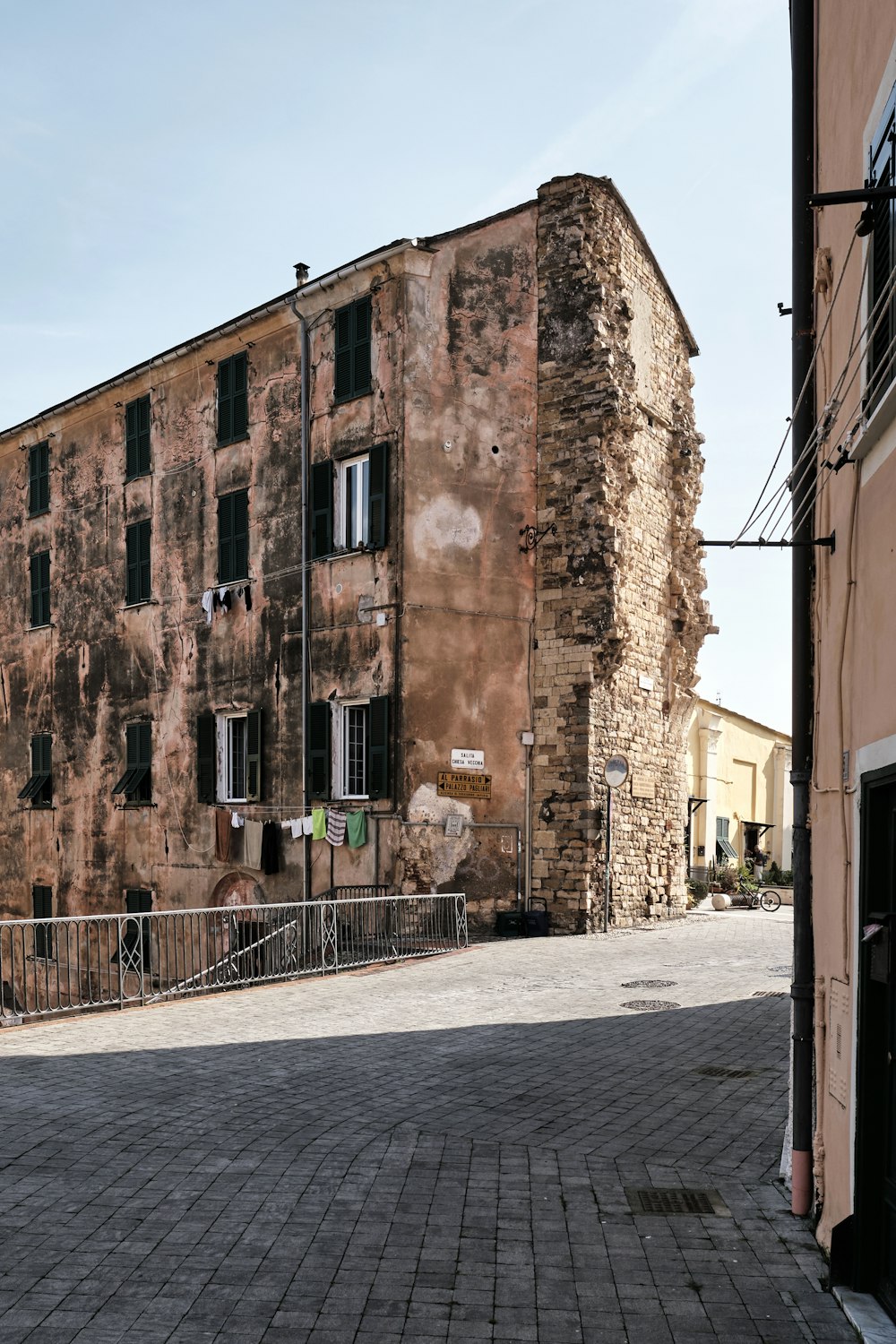 an old brick building sitting on the side of a road