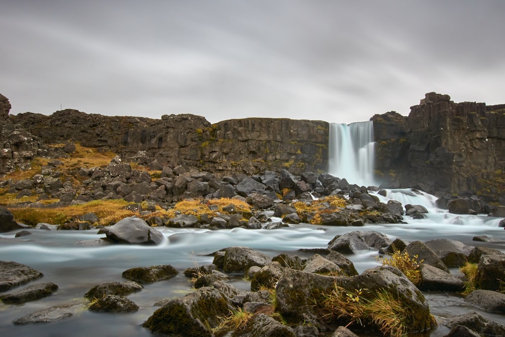 a waterfall with a waterfall in the middle of it